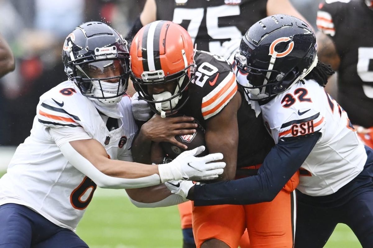 Dec 17, 2023; Cleveland, Ohio, USA; Chicago Bears cornerback Kyler Gordon (6) and cornerback Terell Smith (32) tackle Cleveland Browns running back Pierre Strong Jr. (20) during the first quarter at Cleveland Browns Stadium.