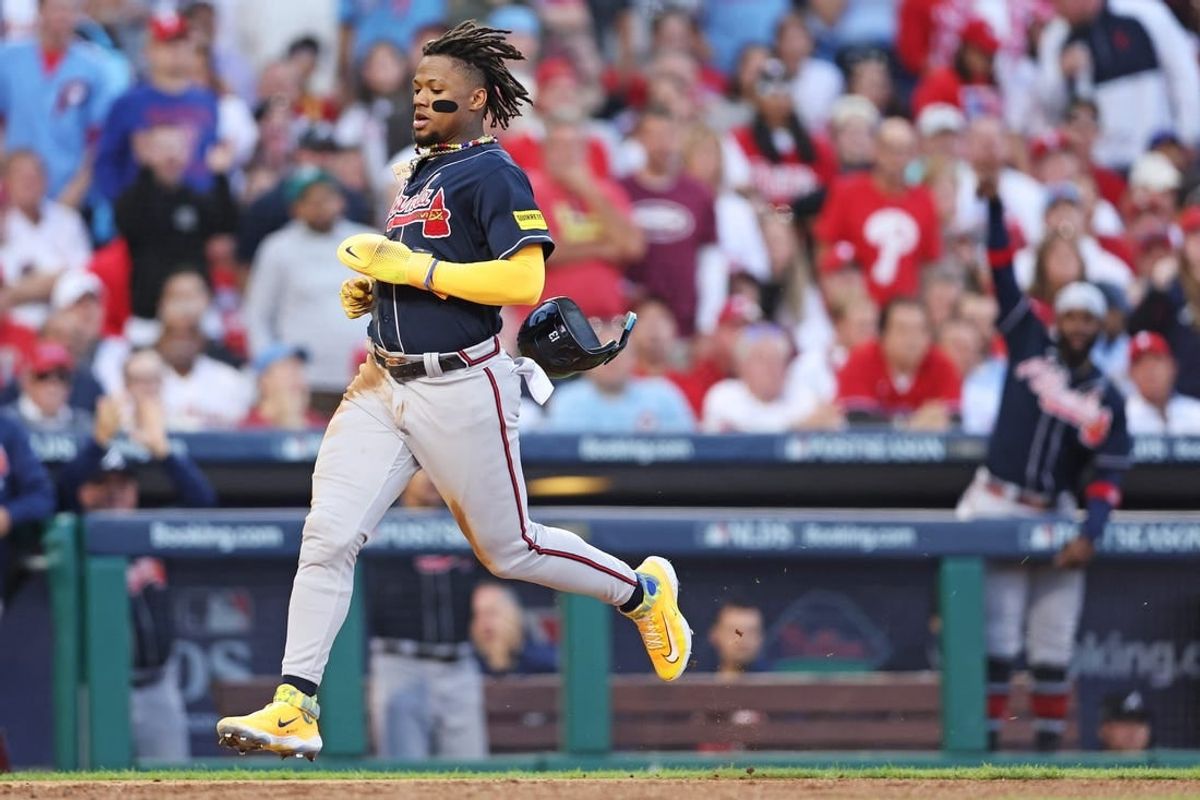 Oct 11, 2023; Philadelphia, Pennsylvania, USA; Atlanta Braves right fielder Ronald Acuna Jr. (13) scores a run on a hit by second baseman Ozzie Albies (not pictured) during the third inning against the Philadelphia Phillies in game three of the NLDS for the 2023 MLB playoffs at Citizens Bank Park.