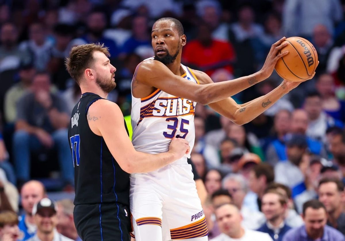 Feb 22, 2024; Dallas, Texas, USA;  Phoenix Suns forward Kevin Durant (35) controls the ball as Dallas Mavericks guard Luka Doncic (77) defends during the first half at American Airlines Center.