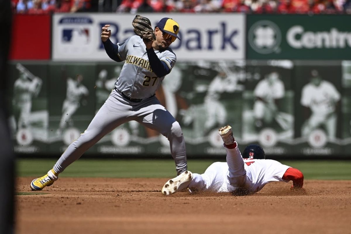 Apr 21, 2024; St. Louis, Missouri, USA; St. Louis Cardinals center fielder Michael Siani (63) safely steals second base ahead of the tag from Milwaukee Brewers shortstop Willy Adames (27) in the second inning at Busch Stadium.