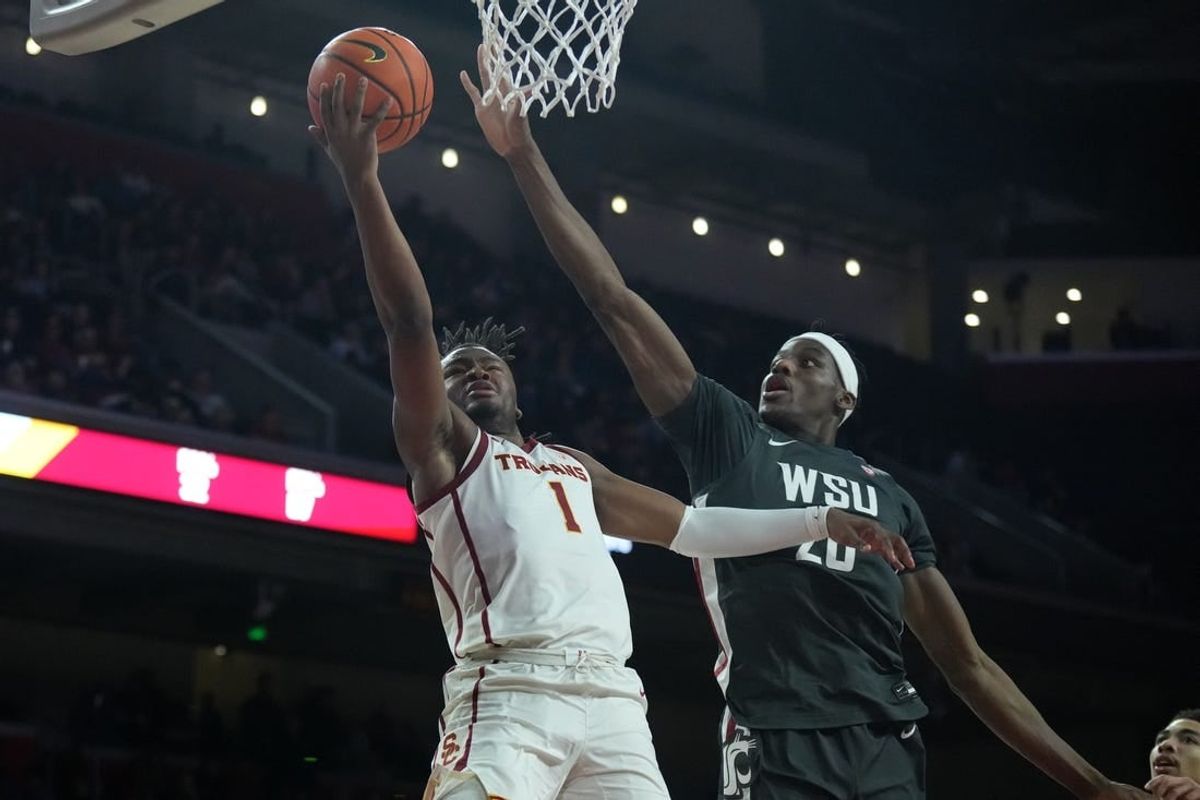 Jan 10, 2024; Los Angeles, California, USA; Southern California Trojans guard Isaiah Collier (1) shoots the ball against Washington State Cougars center Rueben Chinyelu (20) in the second half at Galen Center.