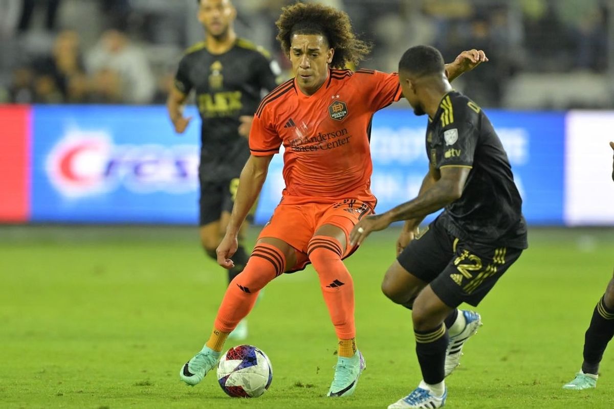 Dec 2, 2023; Los Angeles, California, USA; Houston Dynamo midfielder Adalberto Carrasquilla (20) kicks the ball past Los Angeles FC defender Diego Palacios (12) in the second half for the MLS Cup Western Conference Final at BMO Stadium.