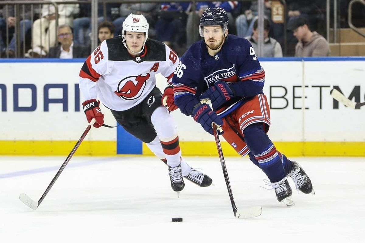 Apr 3, 2024; New York, New York, USA; New York Rangers center Jack Roslovic (96) and New Jersey Devils center Jack Hughes (86) chase the puck in the second period at Madison Square Garden.