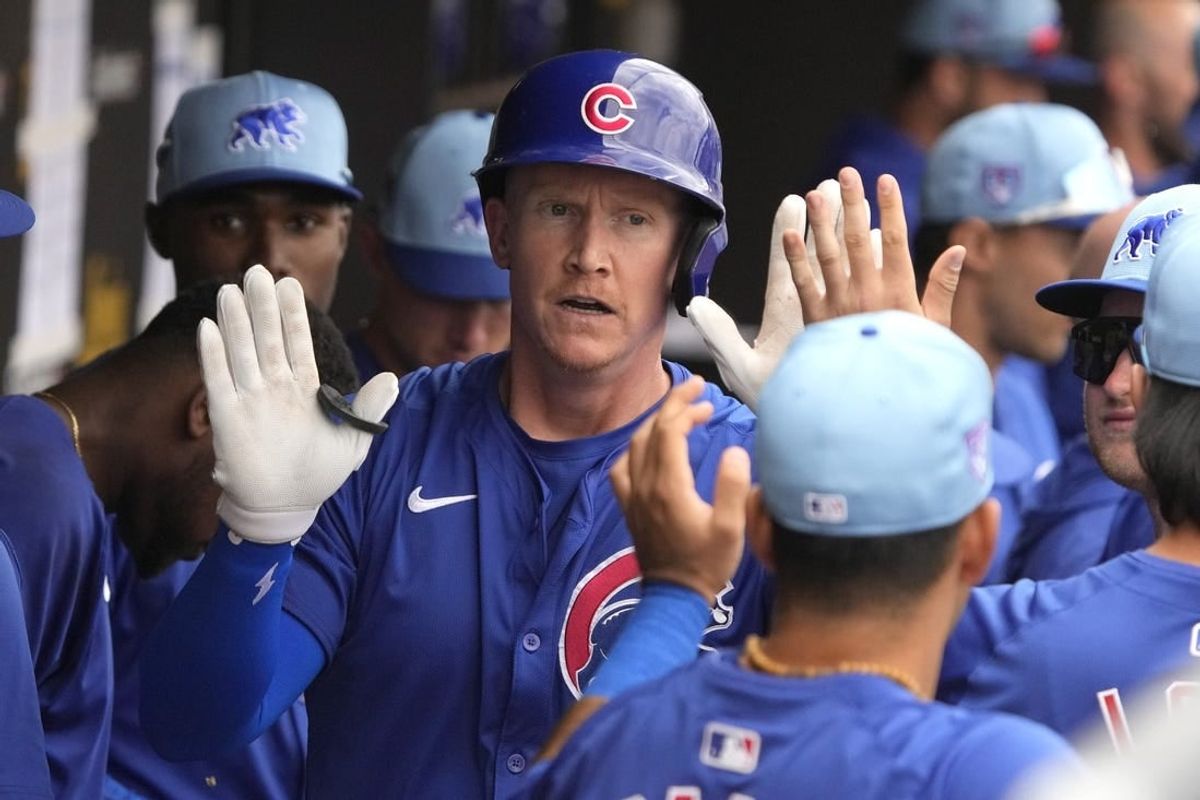 Mar 24, 2024; Peoria, Arizona, USA; Chicago Cubs left fielder Garrett Cooper (41) celebrates with teammates after hitting a home run against the Seattle Mariners in the third inning at Peoria Sports Complex.