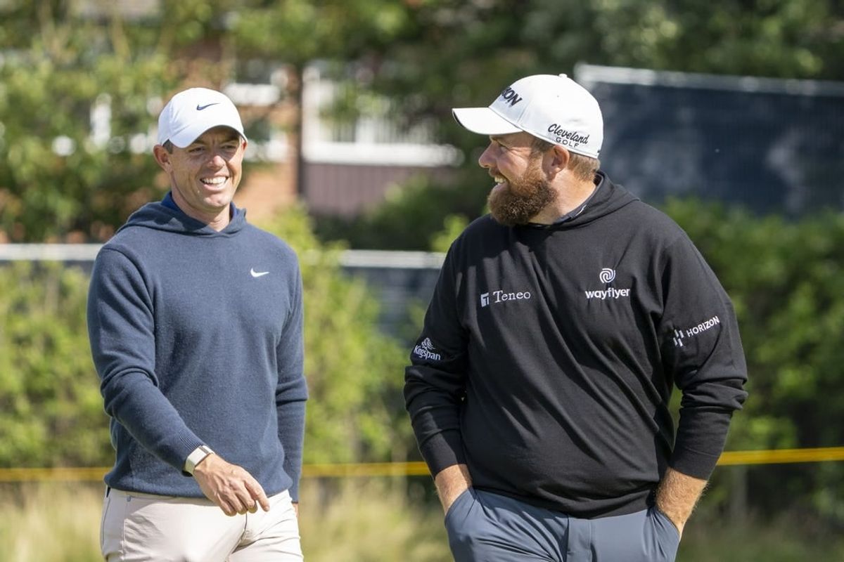 July 17, 2023; Hoylake, ENGLAND, GBR; Rory McIlroy (left) and Shane Lowry (right) smile on the fourth hole during a practice round of The Open Championship golf tournament at Royal Liverpool.