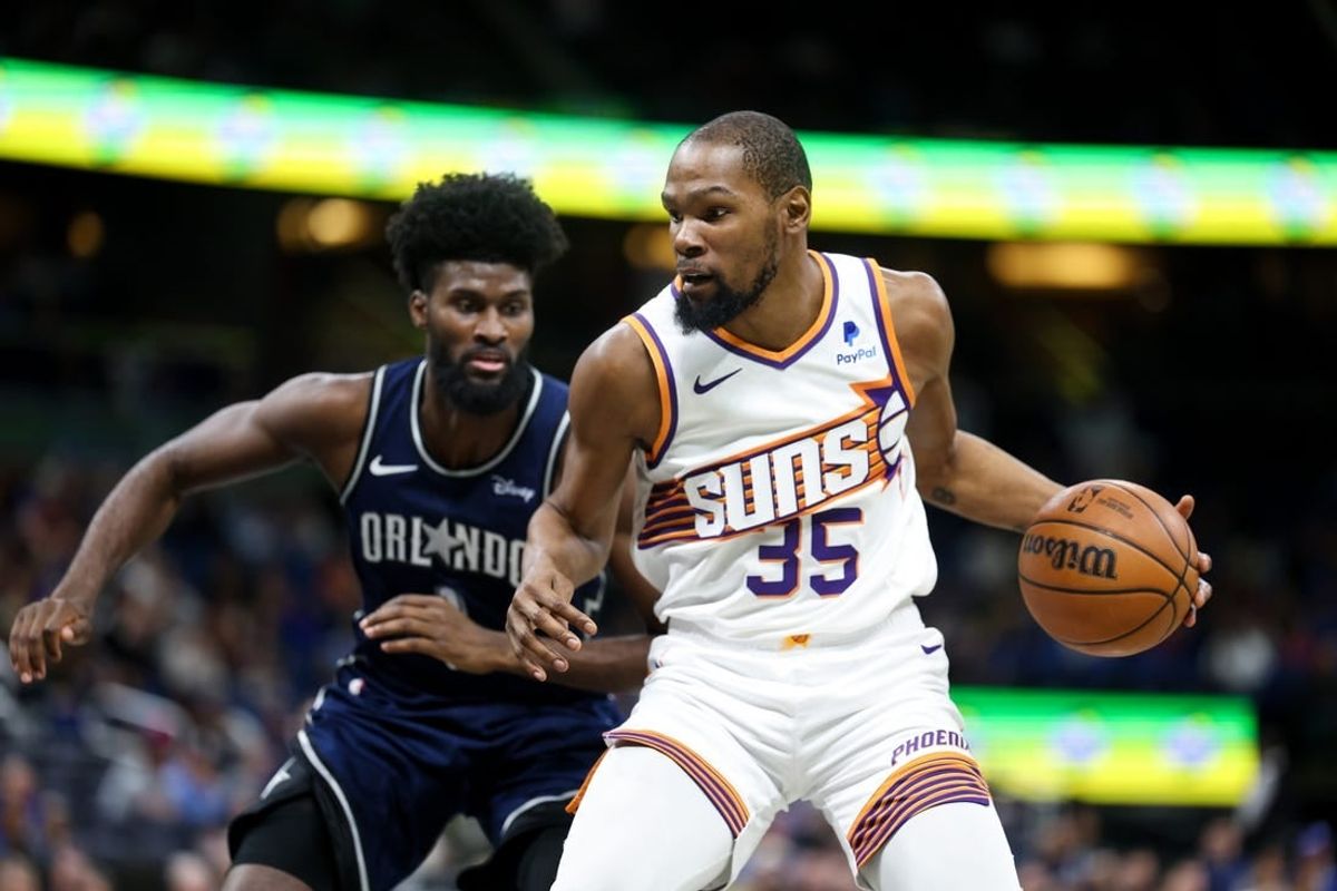 Jan 28, 2024; Orlando, Florida, USA;  Phoenix Suns forward Kevin Durant (35) drives to the hoop past Orlando Magic forward Jonathan Isaac (1) in the second quarter at the Kia Center.