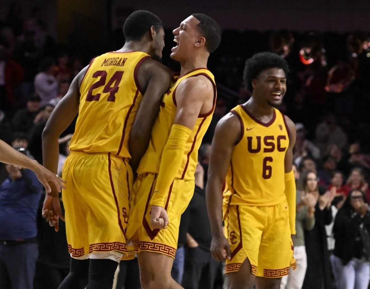 Feb 15, 2024; Los Angeles, California, USA; Southern California Trojans guard Kobe Johnson (center) celebrates with forward Joshua Morgan (24) and guard Bronny James (6) after the Trojans defeat the Utah Utes in a NCAA basketball game at Galen Center.