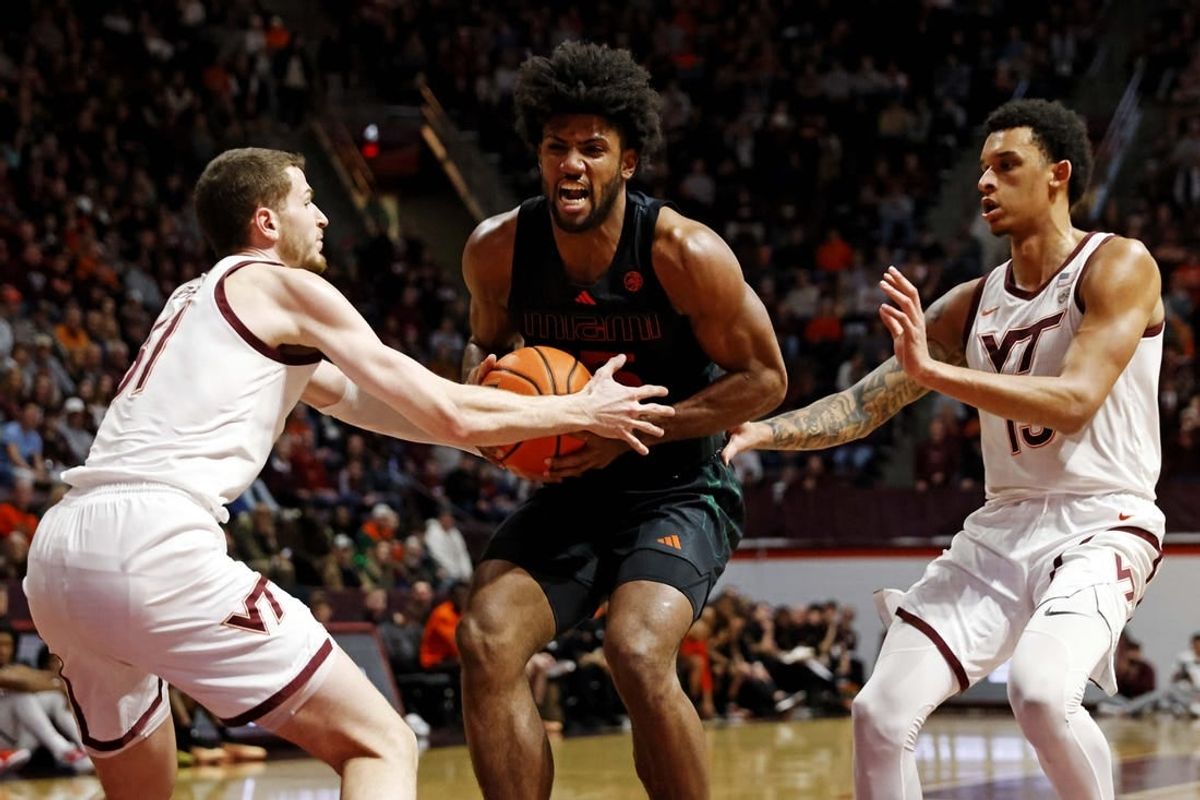 Jan 13, 2024; Blacksburg, Virginia, USA; Miami Hurricanes forward Norchad Omier (15) drives to the basket against Virginia Tech Hokies forward Robbie Beran (31) and center Lynn Kidd (15) during the first half at Cassell Coliseum.