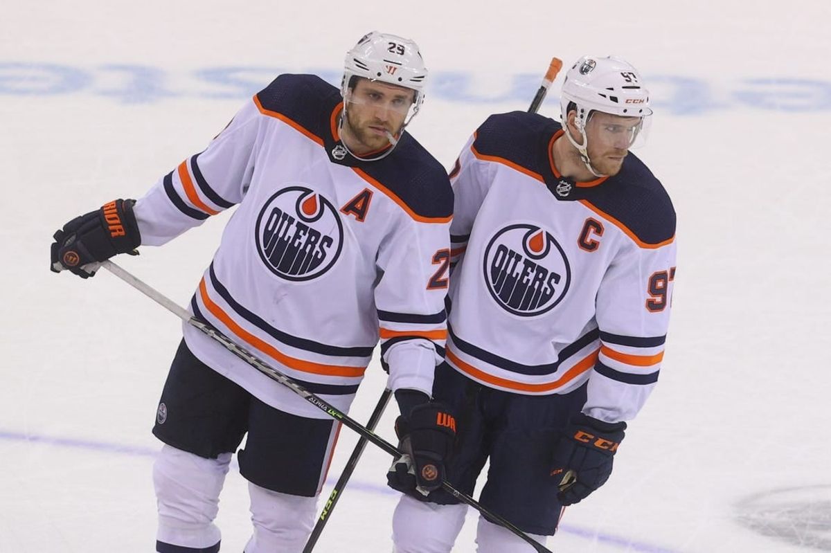 Dec 31, 2021; Newark, New Jersey, USA; Edmonton Oilers center Leon Draisaitl (29) and Edmonton Oilers center Connor McDavid (97) talk during overtime of their game against the New Jersey Devils at Prudential Center.