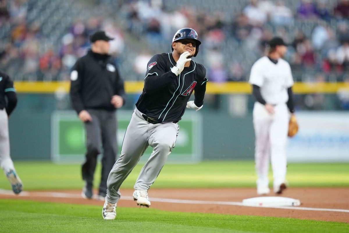 Apr 9, 2024; Denver, Colorado, USA; Arizona Diamondbacks Gabriel Moreno (14) heads home to score a run  in the first inning against the Colorado Rockies at Coors Field.