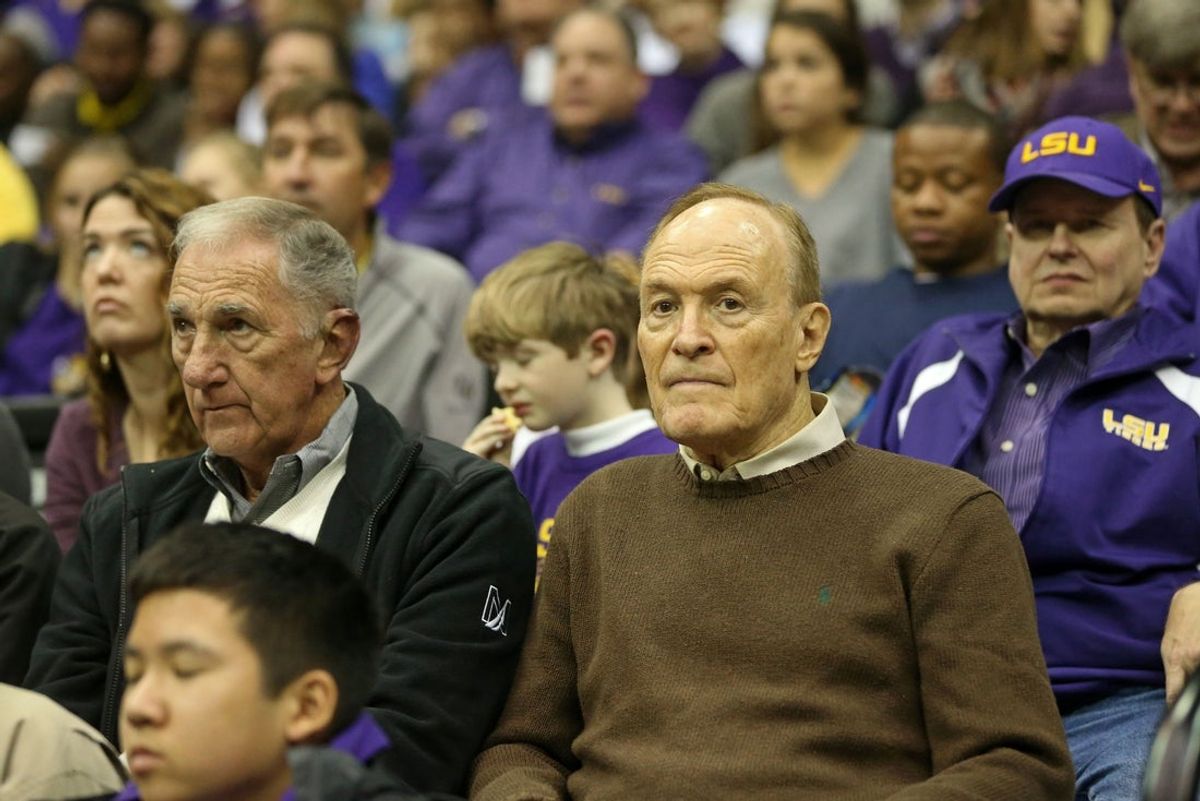 Dec 29, 2015; Baton Rouge, LA, USA; Former LSU Tigers head basketball coach Dale Brown, right, watches the Tigers play the Wake Forest Demon Deacons at the Pete Maravich Assembly Center. Wake Forest won, 77-71. Mandatory Credit: Chuck Cook-Imagn Images