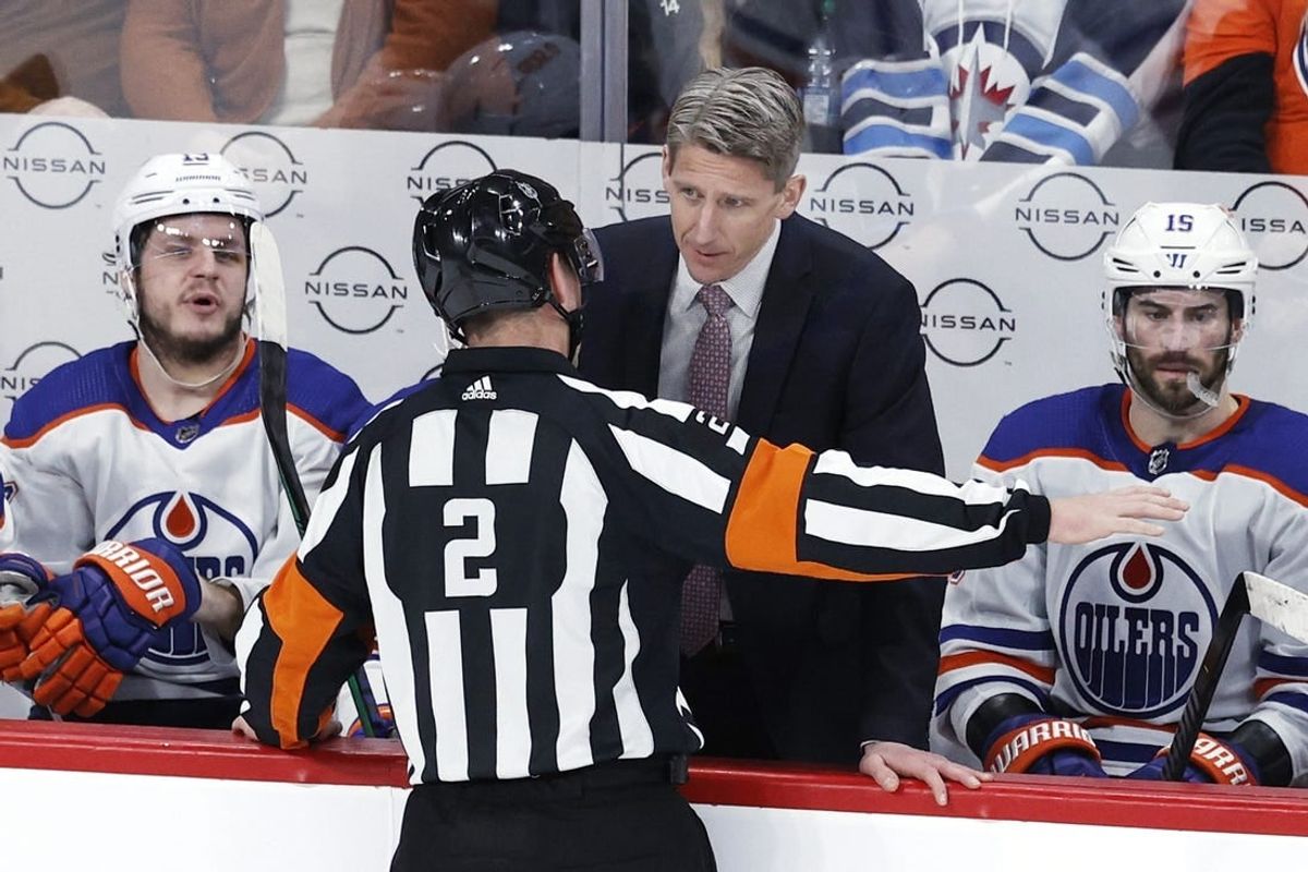 Mar 26, 2024; Winnipeg, Manitoba, CAN; Edmonton Oilers head coach Kris Knoblauch discusses a call with referee Jon McIsaac (2) in the third period against the Winnipeg Jets at Canada Life Centre.