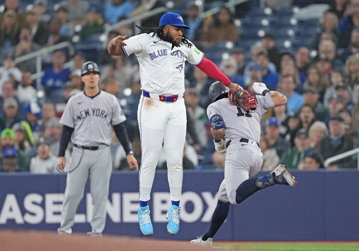 Apr 17, 2024; Toronto, Ontario, CAN; Toronto Blue Jays first base Vladimir Guerrero Jr. (27) tags out New York Yankees shortstop Anthony Volpe (11) at first base during the first inning at Rogers Centre.