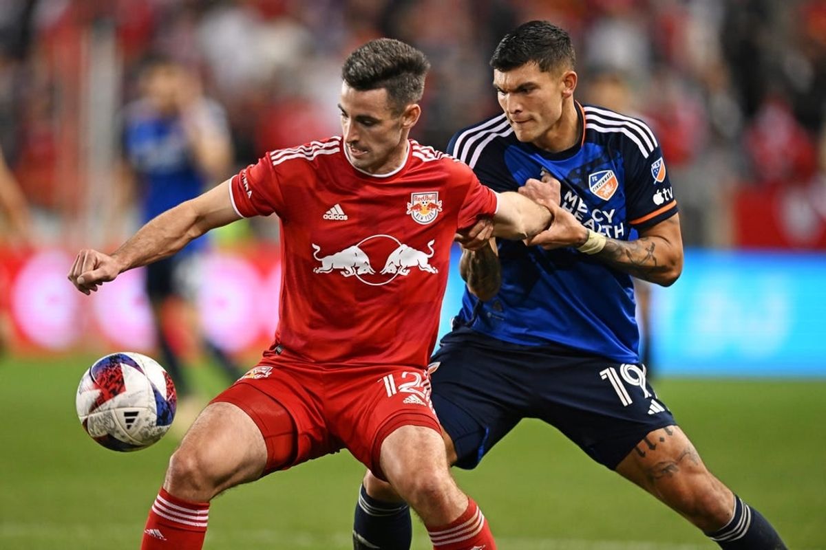 Nov 4, 2023; Harrison, NJ, USA; New York Red Bulls defender Dylan Nealis (12) and FC Cincinnati forward Brandon V  zquez (19) battle for the ball during the second half of game two in a round one match of the 2023 MLS Cup Playoffs at Red Bull Arena.