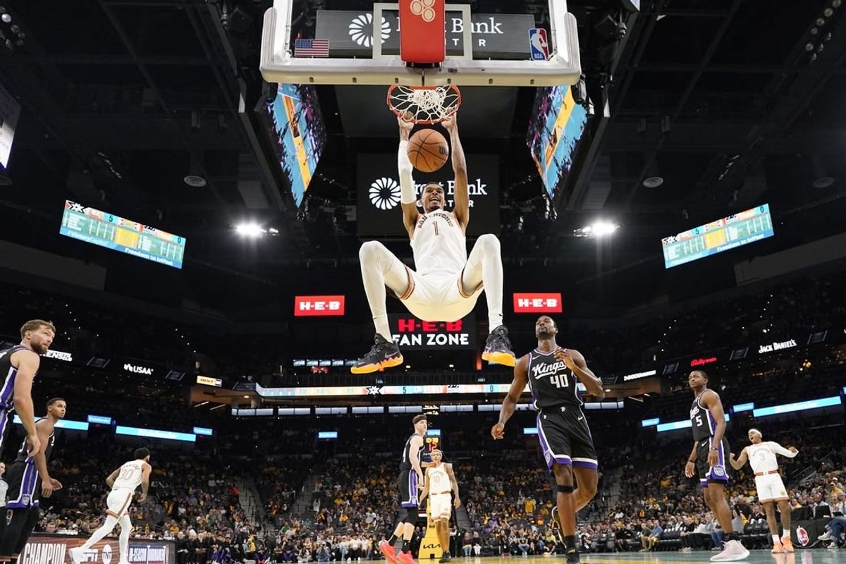 Nov 17, 2023; San Antonio, Texas, USA; San Antonio Spurs forward Victor Wembanyama (1) dunks during the first half against the Sacramento Kings at Frost Bank Center.