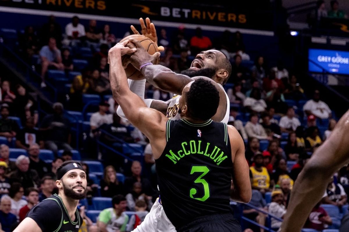 Apr 14, 2024; New Orleans, Louisiana, USA; Los Angeles Lakers forward LeBron James (23) is fouled by New Orleans Pelicans guard CJ McCollum (3) during the second half at Smoothie King Center.