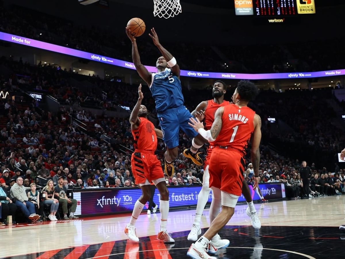 Feb 13, 2024; Portland, Oregon, USA;  Minnesota Timberwolves guard Anthony Edwards (5) shoots the ball over Portland Trail Blazers forward Jerami Grant (9), center Deandre Ayton (2), and guard Anfernee Simons (1) in the second quarter at Moda Center.