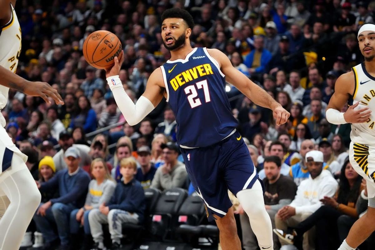Jan 14, 2024; Denver, Colorado, USA; Denver Nuggets guard Jamal Murray (27) passes the ball in the first quarter against the Indiana Pacers at Ball Arena.