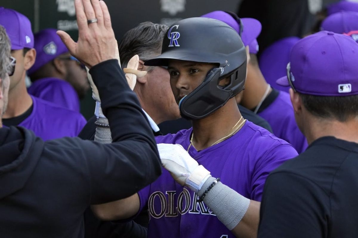 Feb 29, 2024; Mesa, Arizona, USA; Colorado Rockies shortstop Ezequiel Tovar (14) celebrates with teammates after hitting a solo home run against the Chicago Cubs in the third inning at Sloan Park.