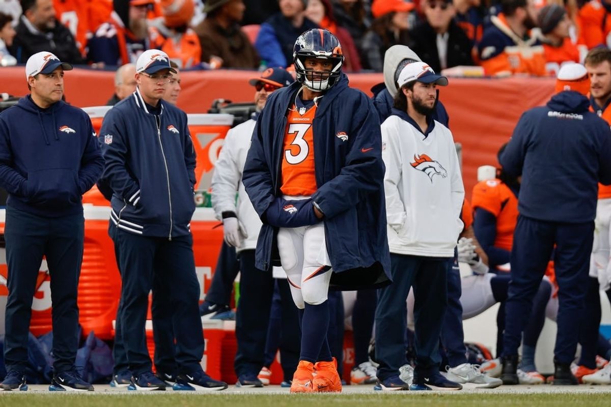 Dec 31, 2023; Denver, Colorado, USA; Denver Broncos quarterback Russell Wilson (3) looks on from the sideline in the first quarter against the Los Angeles Chargers at Empower Field at Mile High.