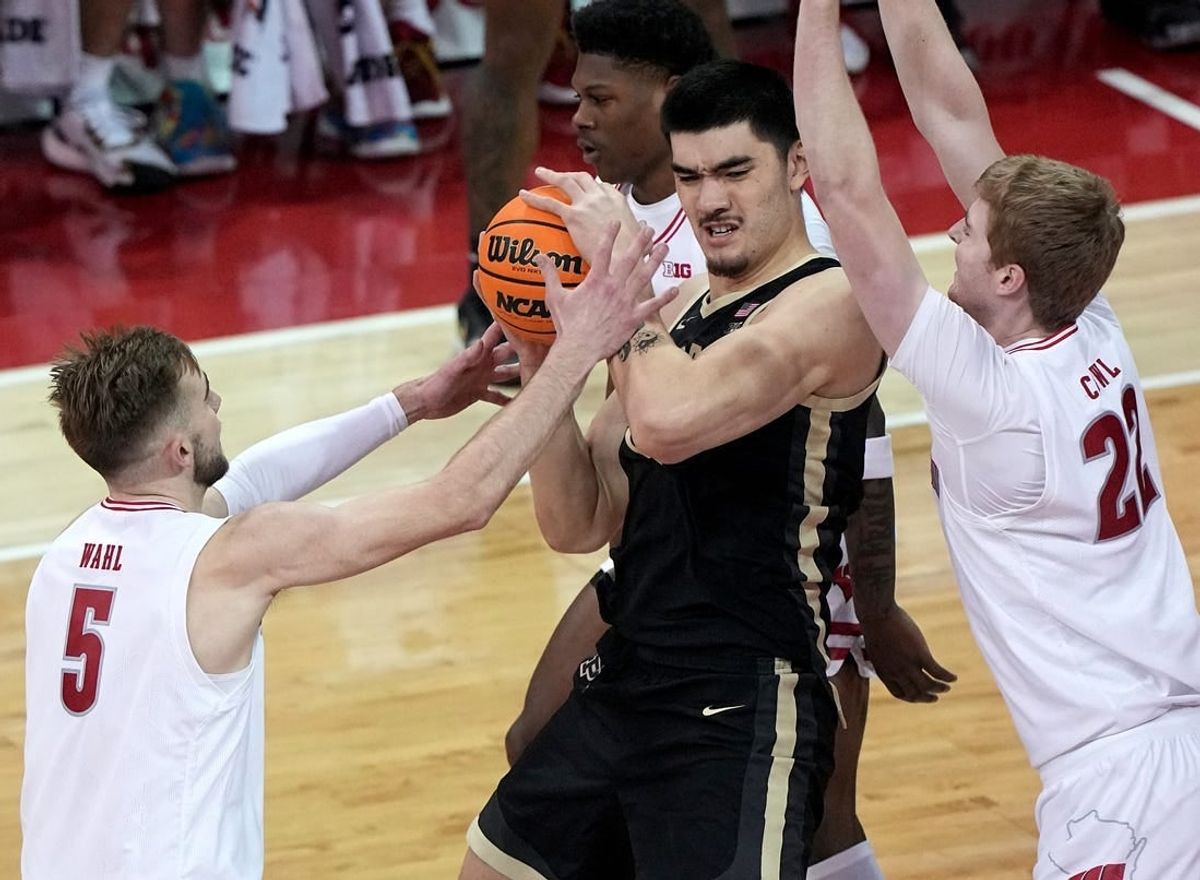 Feb 4, 2024; Madison, Wisconsin, USA; Purdue   s Zach Edey (15) is swamped by Wisconsin forward Tyler Wahl (5) and forward Steven Crowl (22) during the first half at Kohl Center.