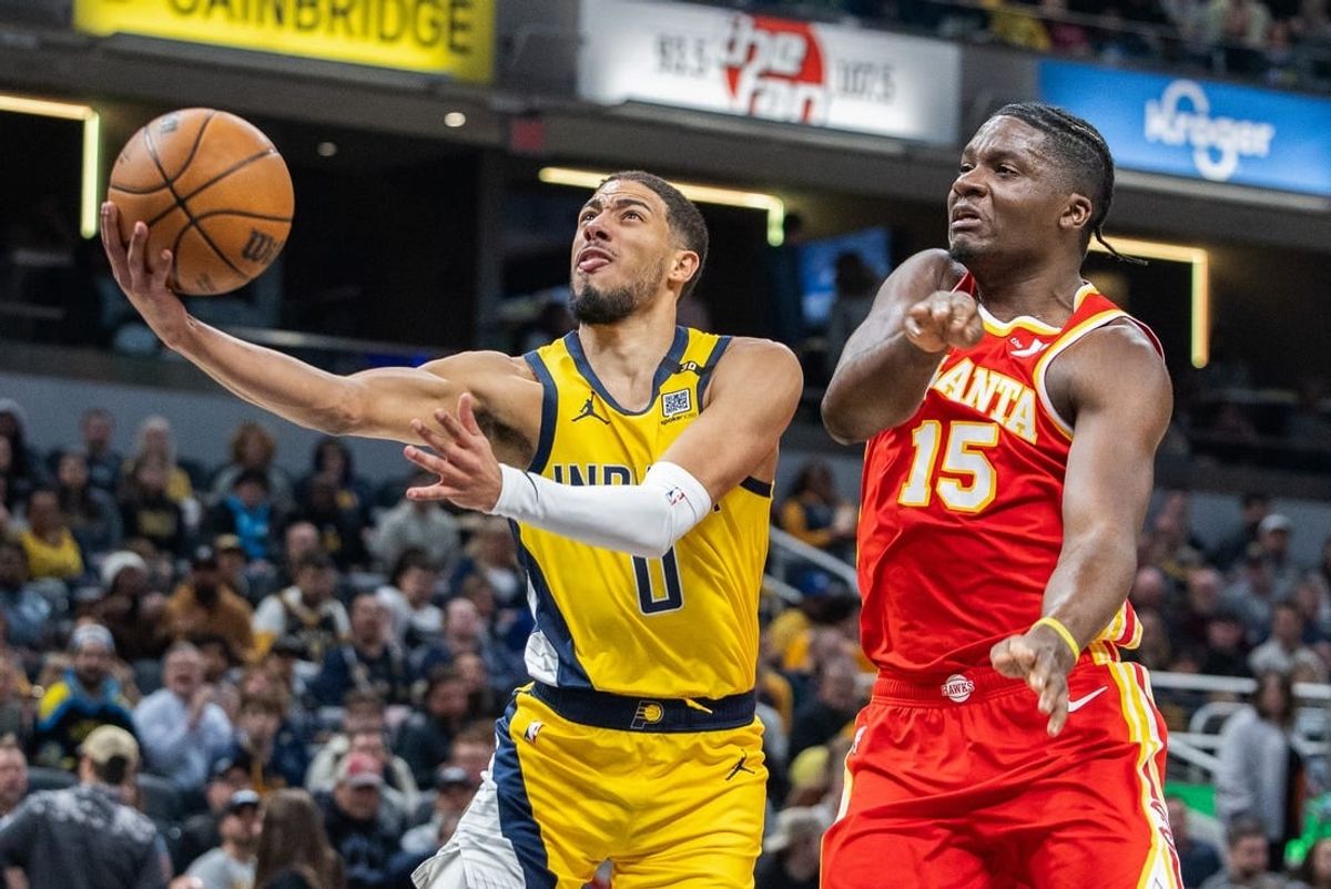 Jan 5, 2024; Indianapolis, Indiana, USA; Indiana Pacers guard Tyrese Haliburton (0) shoots the ball while Atlanta Hawks center Clint Capela (15) defends in the first quarter at Gainbridge Fieldhouse.