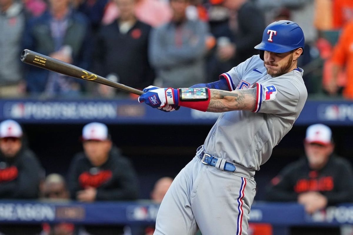 Oct 8, 2023; Baltimore, Maryland, USA; Texas Rangers catcher Jonah Heim (28) hits an RBI single during the second inning against the Baltimore Orioles during game two of the ALDS for the 2023 MLB playoffs at Oriole Park at Camden Yards.