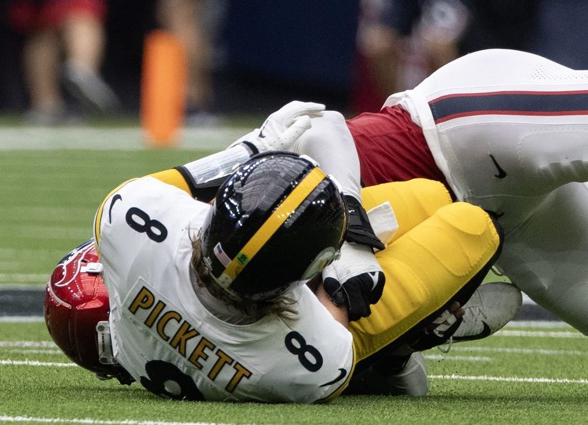 Oct 1, 2023; Houston, Texas, USA; Pittsburgh Steelers quarterback Kenny Pickett (8) is injured as he is sacked by Houston Texans defensive end Jonathan Greenard (52) in the second half at NRG Stadium.