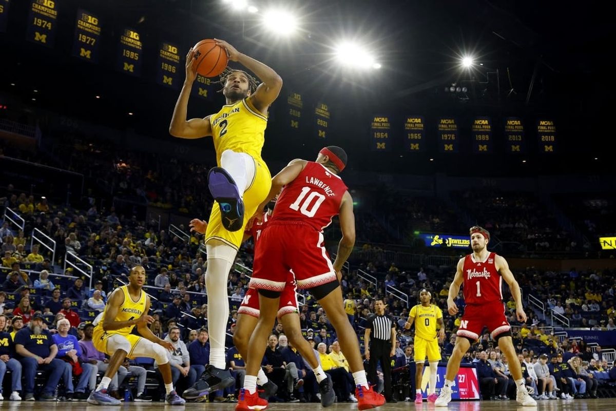 Mar 10, 2024; Ann Arbor, Michigan, USA;  Michigan Wolverines forward Tray Jackson (2) grabs the rebound over Nebraska Cornhuskers guard Jamarques Lawrence (10) in the first half at Crisler Center.