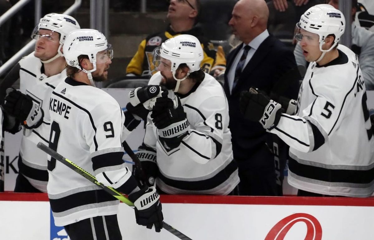 Feb 18, 2024; Pittsburgh, Pennsylvania, USA;  Los Angeles Kings right wing Adrian Kempe (9) celebrates with the Kings bench after scoring the game winning goal against the Pittsburgh Penguins during the third period at PPG Paints Arena. Los Angeles won 2-1.