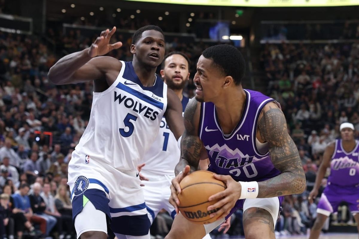 Mar 18, 2024; Salt Lake City, Utah, USA; Utah Jazz forward John Collins (20) goes to the basket against Minnesota Timberwolves guard Anthony Edwards (5) during the second quarter at Delta Center.