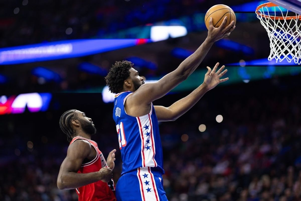 Jan 2, 2024; Philadelphia, Pennsylvania, USA; Philadelphia 76ers center Joel Embiid (21) drives for a score past Chicago Bulls forward Patrick Williams (44) during the second quarter at Wells Fargo Center.
