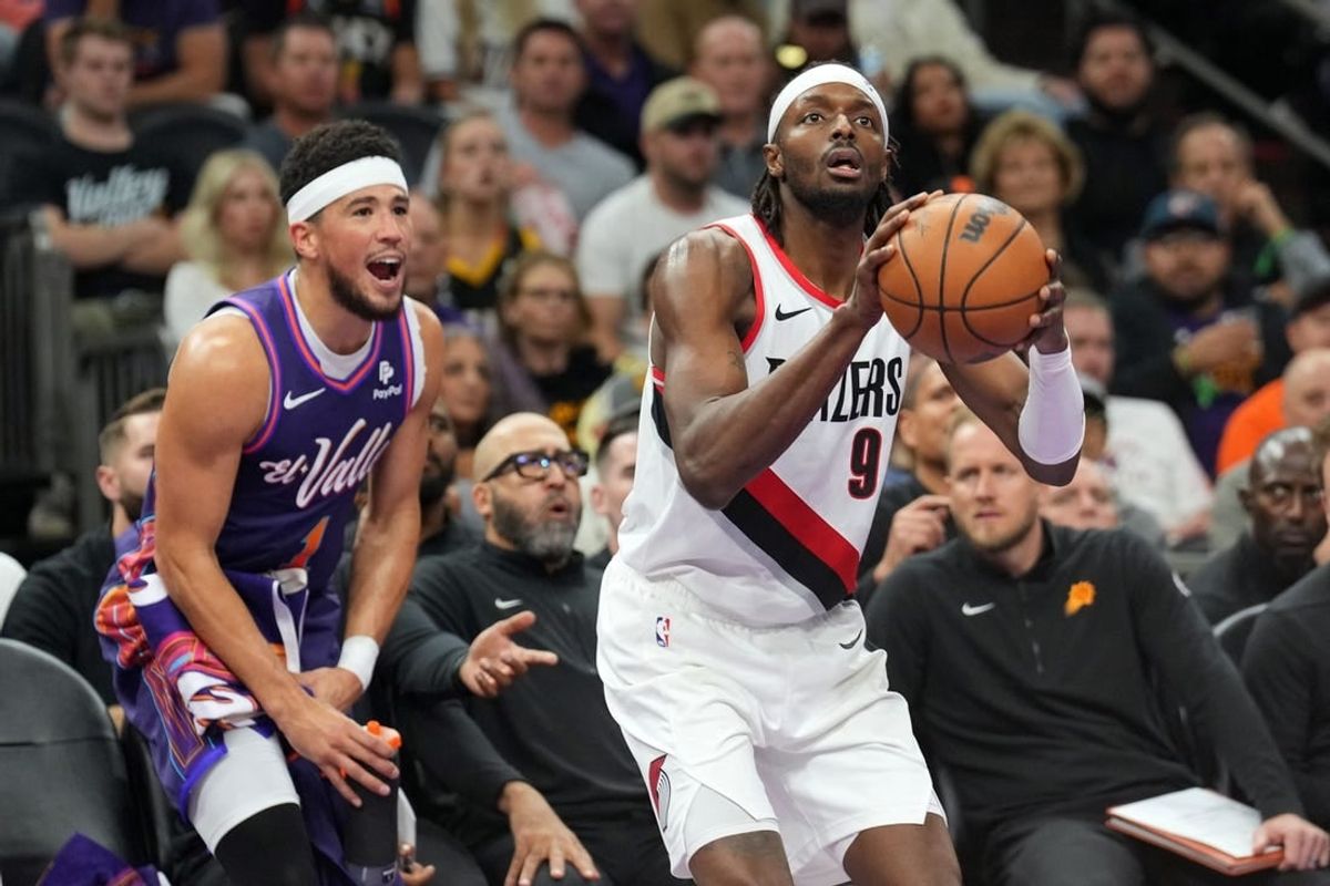 Nov 21, 2023; Phoenix, Arizona, USA; Phoenix Suns guard Devin Booker (1) shouts from the bench as Portland Trail Blazers forward Jerami Grant (9) shoots during the second half at Footprint Center.