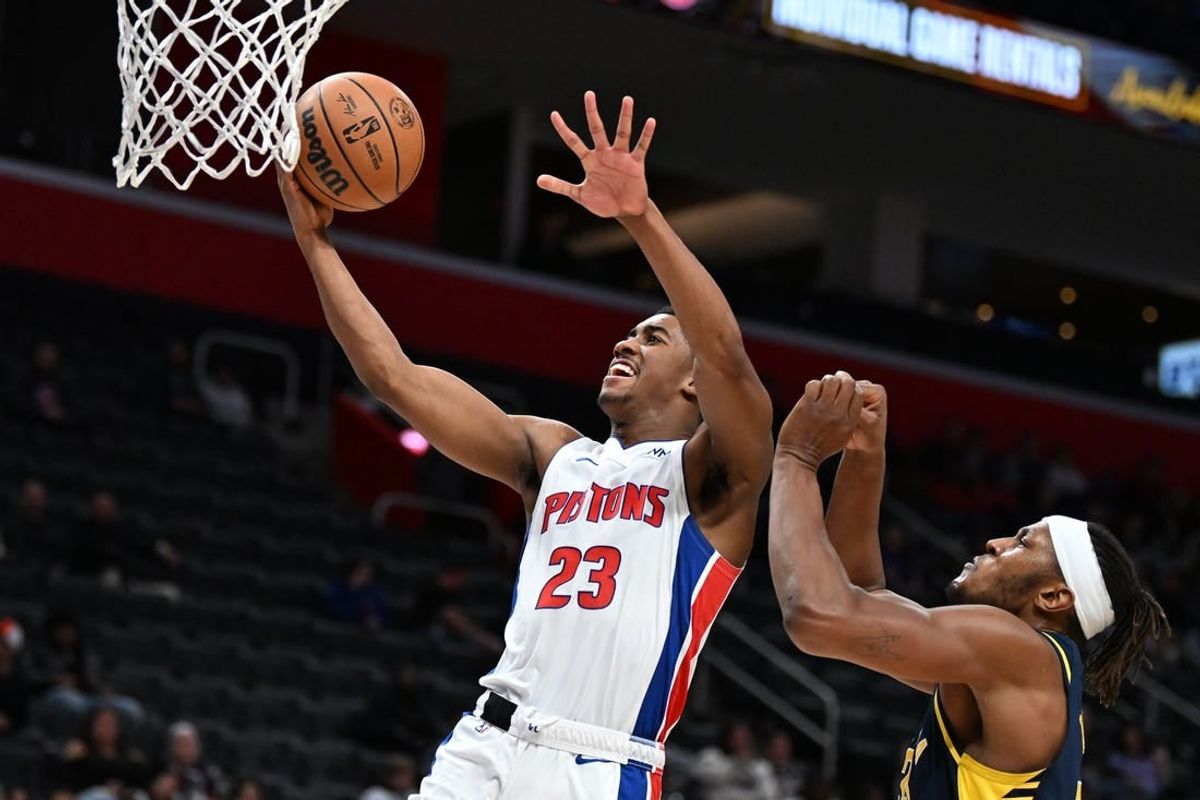 Dec 11, 2023; Detroit, Michigan, USA;  Detroit Pistons guard Jaden Ivey (23) drives to the basket for a layup over Indiana Pacers forward Isaiah Jackson (22) in the fourth quarter at Little Caesars Arena.
