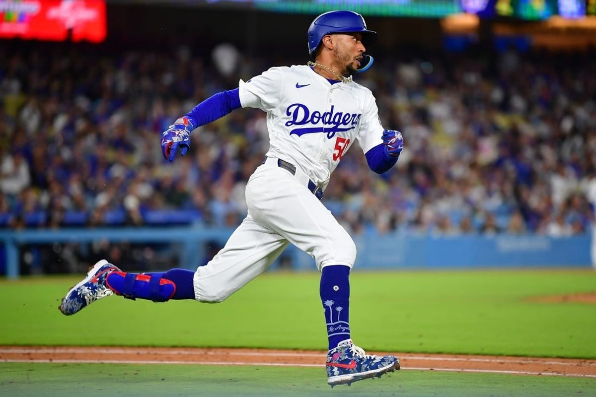 Apr 16, 2024; Los Angeles, California, USA; Los Angeles Dodgers shortstop Mookie Betts (50) runs after hitting a double against the Washington Nationals during the seventh inning at Dodger Stadium.