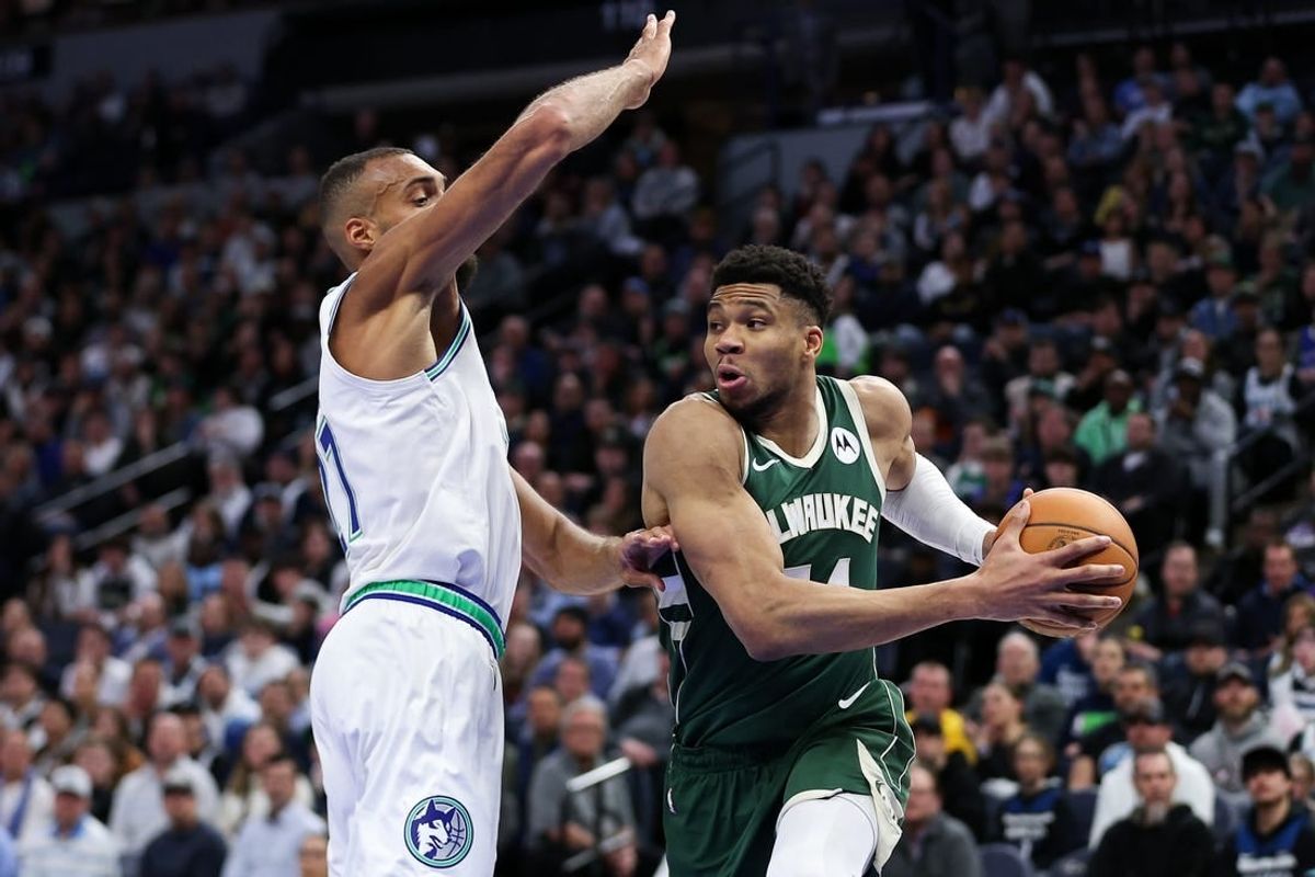 Feb 23, 2024; Minneapolis, Minnesota, USA; Milwaukee Bucks forward Giannis Antetokounmpo (34) works around Minnesota Timberwolves center Rudy Gobert (27) during the first half at Target Center.