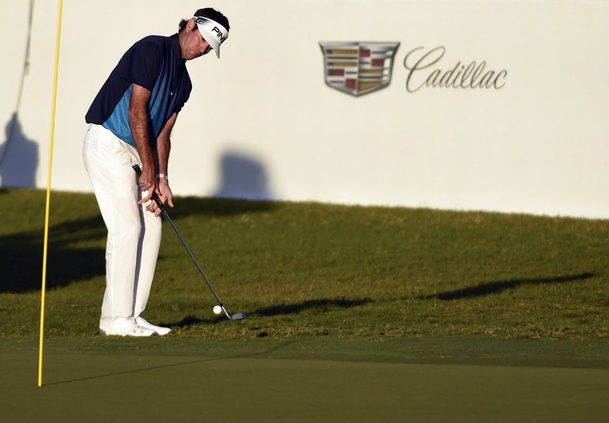 Mar 6, 2016; Miami, FL, USA; Bubba Watson chips up onto the 18th green from the fringe during the final round at Trump National Doral. Mandatory Credit: John David Mercer-Imagn Images