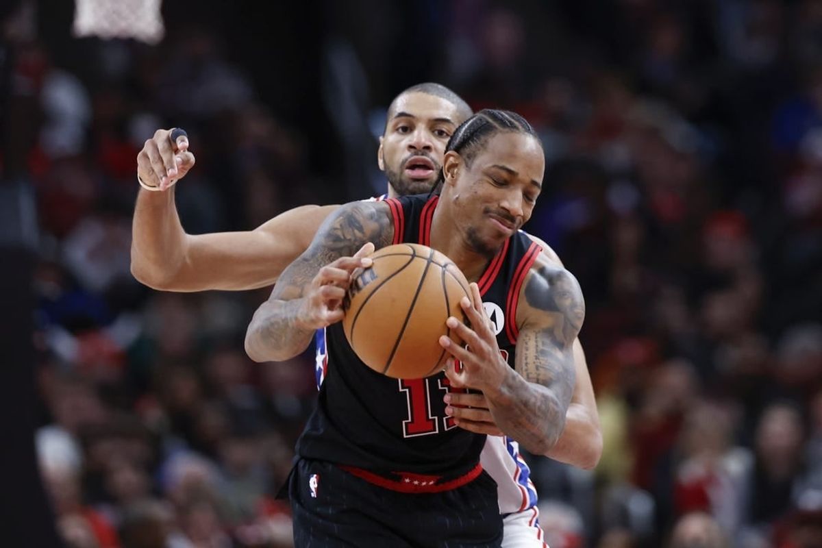 Dec 30, 2023; Chicago, Illinois, USA; Philadelphia 76ers forward Nicolas Batum (40) defends against Chicago Bulls forward DeMar DeRozan (11) during the second half at United Center.