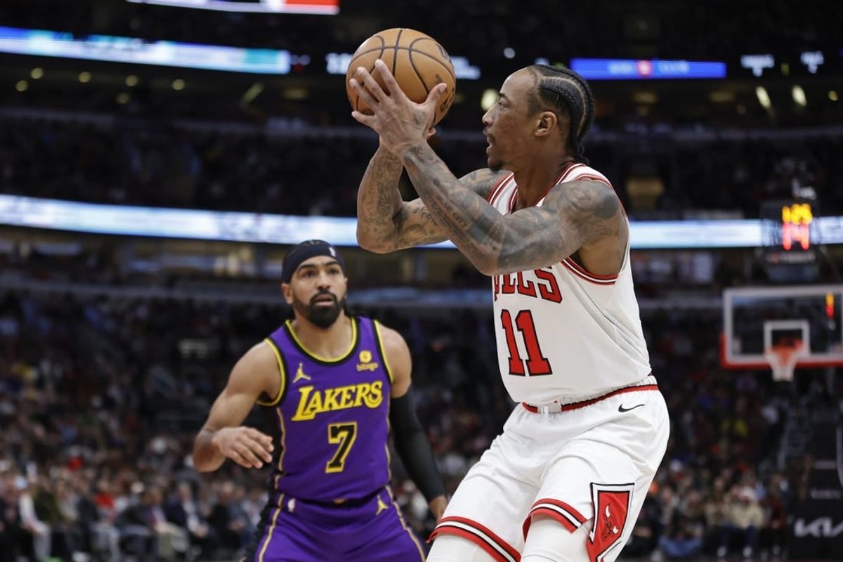Dec 20, 2023; Chicago, Illinois, USA; Chicago Bulls forward DeMar DeRozan (11) shoots against Los Angeles Lakers guard Gabe Vincent (7) during the first half at United Center.