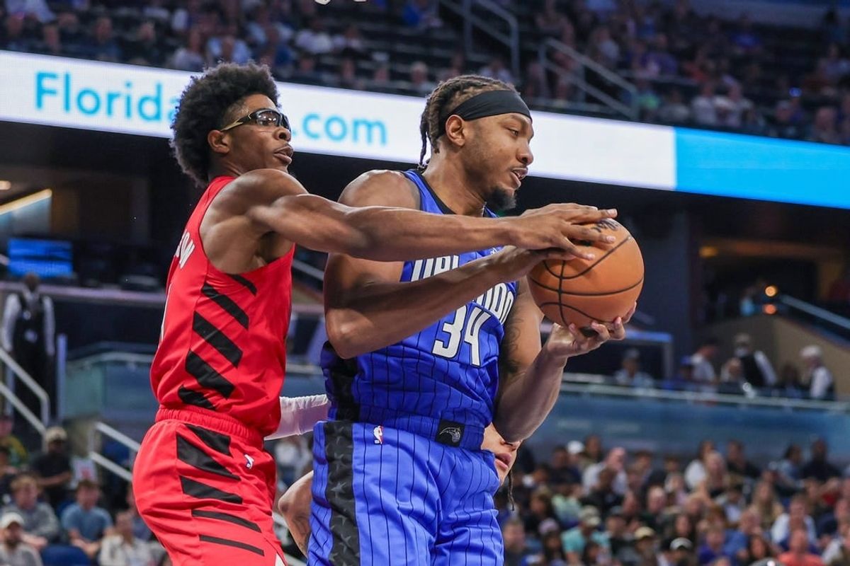 Apr 1, 2024; Orlando, Florida, USA; Orlando Magic center Wendell Carter Jr. (34) grabs the rebound from Portland Trail Blazers guard Scoot Henderson (00) during the first quarter at Amway Center.