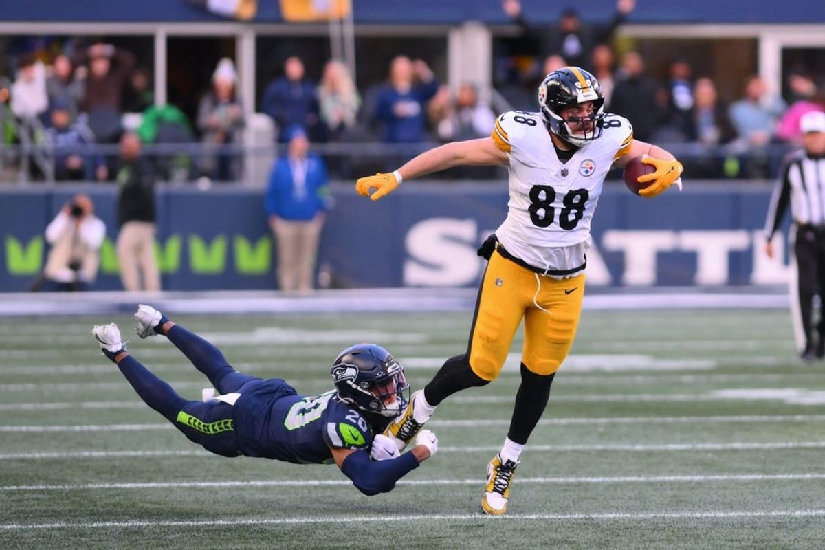 Dec 31, 2023; Seattle, Washington, USA; Pittsburgh Steelers tight end Pat Freiermuth (88) breaks a tackle attempt by Seattle Seahawks running back Zach Charbonnet (26) during the first half at Lumen Field.