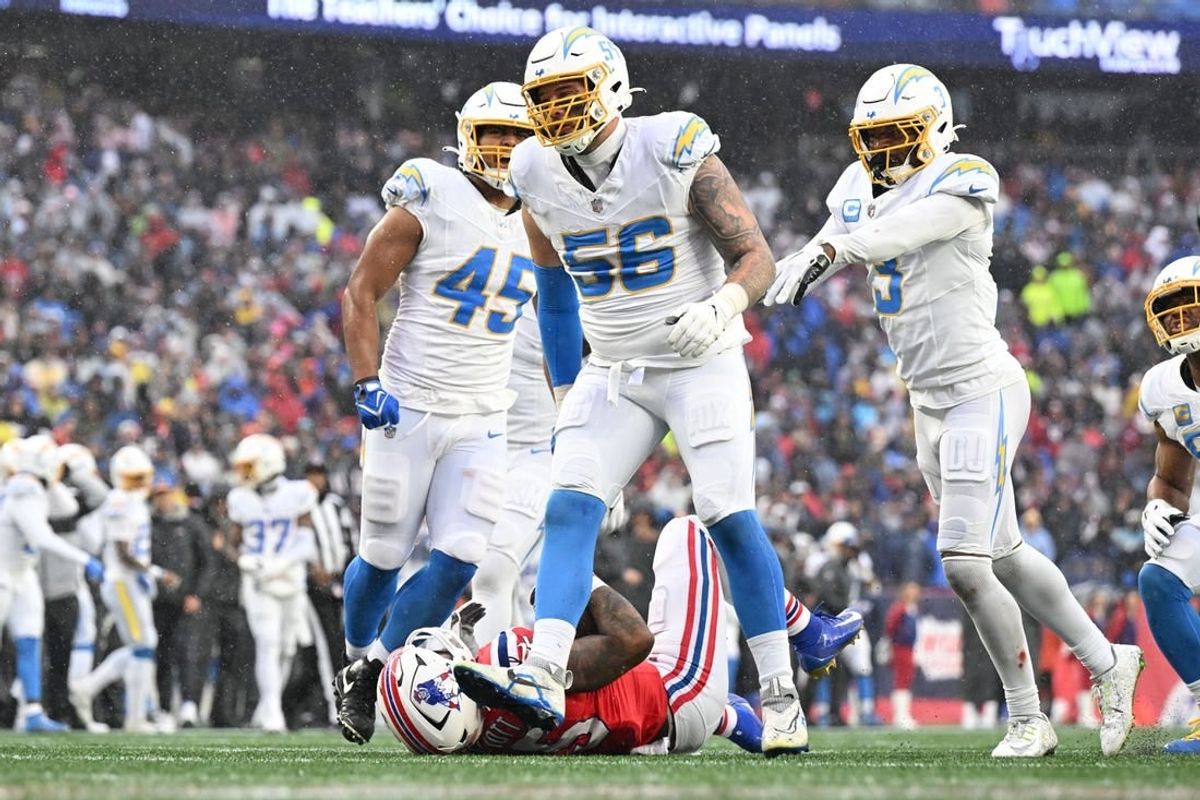 Dec 3, 2023; Foxborough, Massachusetts, USA; Los Angeles Chargers defensive end Morgan Fox (56) reacts after tackling New England Patriots running back Ezekiel Elliott (15) during the first half at Gillette Stadium.
