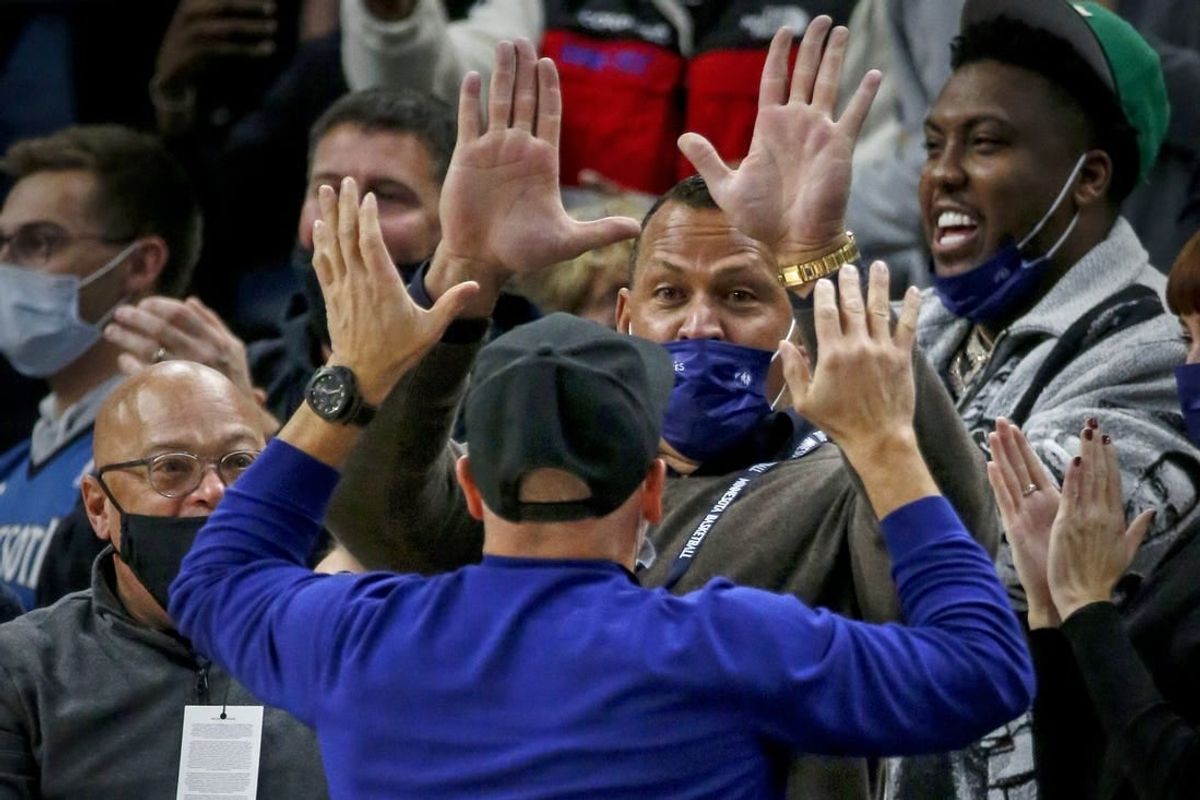 Oct 25, 2021; Minneapolis, Minnesota, USA; Minnesota Timberwolves minority owners Alex Rodriguez and Marc Lore cheer their team on in the third quarter against the New Orleans Pelicans at Target Center.