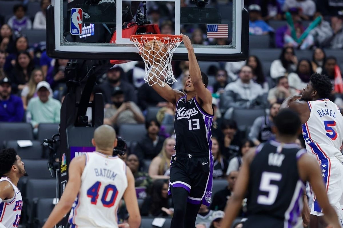 Mar 25, 2024; Sacramento, California, USA; Sacramento Kings forward Keegan Murray (13) dunks the ball against Philadelphia 76ers forward Nicolas Batum (40) during the first quarter at Golden 1 Center.