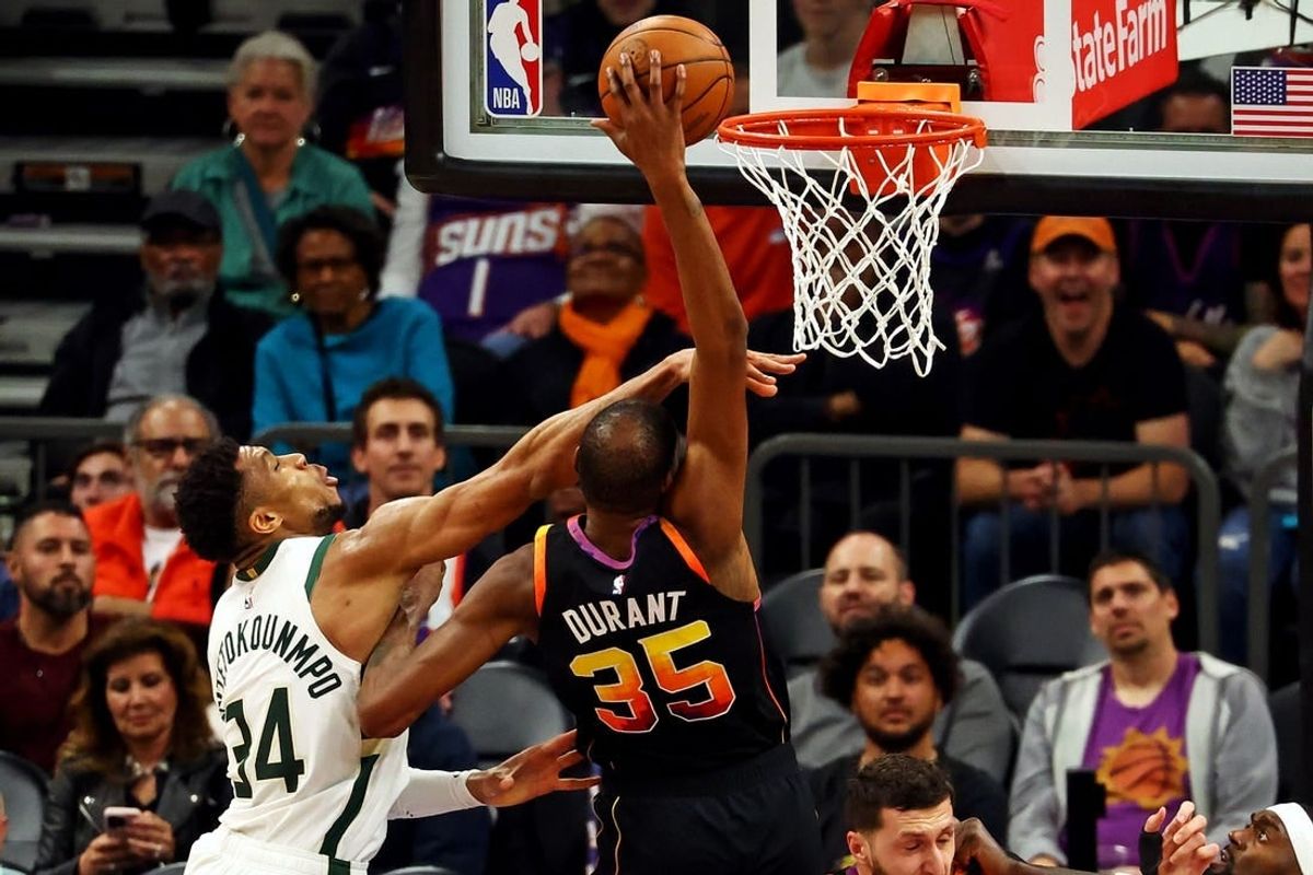Feb 6, 2024; Phoenix, Arizona, USA; Phoenix Suns forward Kevin Durant (35) shoots the ball against Milwaukee Bucks forward Giannis Antetokounmpo (34) during the fourth quarter at Footprint Center.