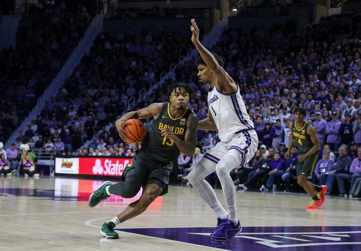 Jan 16, 2024; Manhattan, Kansas, USA; Baylor Bears guard Langston Love (13) dribbles against Kansas State Wildcats forward David N'Guessan (1) during the second half at Bramlage Coliseum.