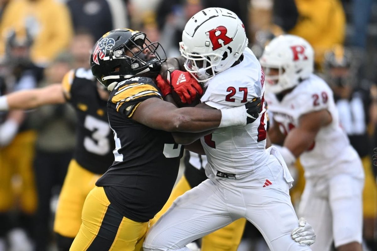 Nov 11, 2023; Iowa City, Iowa, USA; Iowa Hawkeyes linebacker Jay Higgins (34) tackles Rutgers Scarlet Knights running back Samuel Brown V (27) during the second quarter at Kinnick Stadium.
