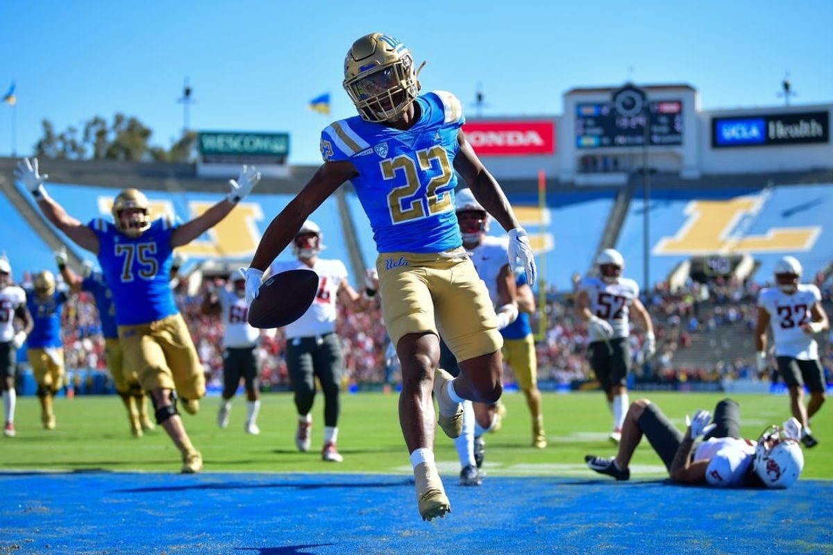 Oct 7, 2023; Pasadena, California, USA; UCLA Bruins wide receiver Keegan Jones (22) scores a touchdown against the Washington State Cougars during the second half at Rose Bowl.