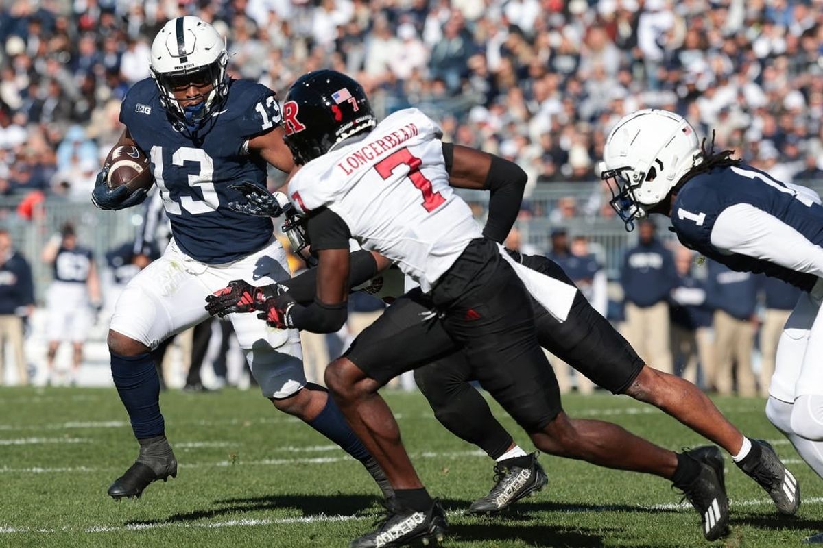 Nov 18, 2023; University Park, Pennsylvania, USA; Penn State Nittany Lions running back Kaytron Allen (13) carries the ball as Rutgers Scarlet Knights defensive back Robert Longerbeam (7) pursues during the first half at Beaver Stadium.