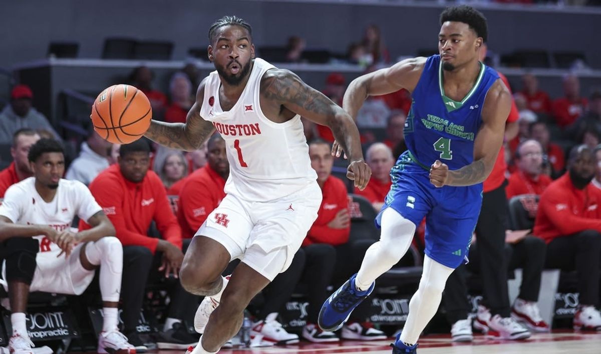 Nov 11, 2023; Houston, Texas, USA; Houston Cougars guard Jamal Shead (1) looks to pass the ball as Texas A&M-CC Islanders guard Kam Parker (4) defends during the second half at Fertitta Center.